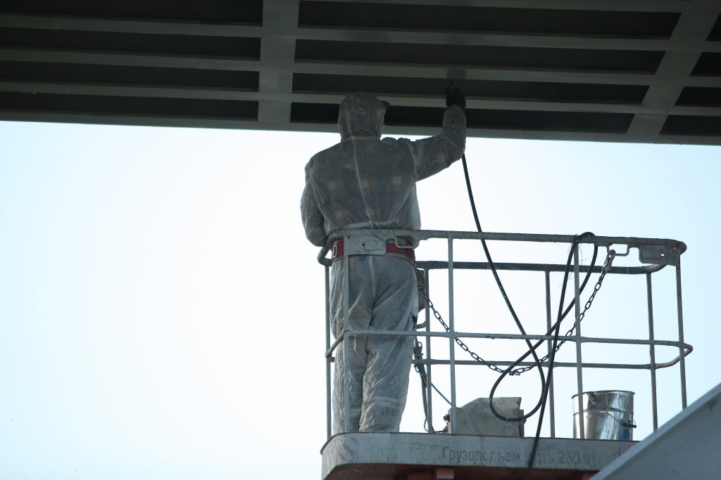 spray painting architectural steel from a boom